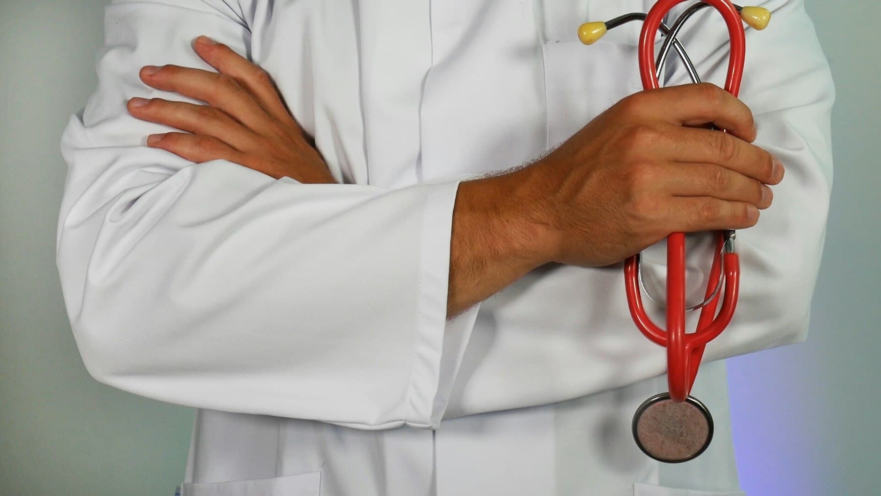 Doctor in a white coat holding a stethoscope